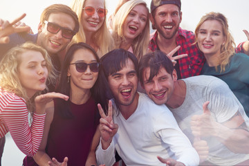 Positive young people posing in front on the camera