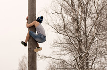 Festival. Boy Climbs On A Pole