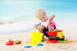 © famveldman - Kids play on tropical beach. Sand and water toy.