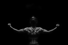 Fit Woman Demonstrate Perfect Back And Shoulders On Black Background