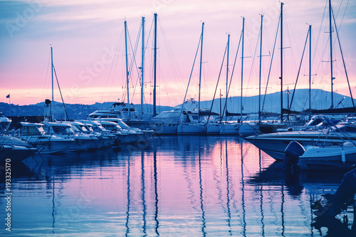 Cuadros en Lienzo dock with white boats and yachts on a beautiful colorful sunset on the Cote d'Az