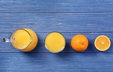 Canvas Print - Beautiful composition with fresh orange juice on wooden table, top view