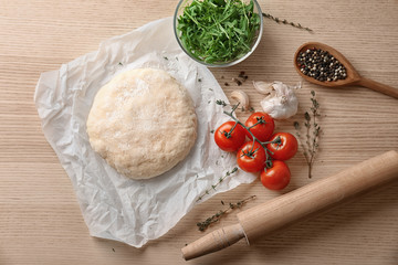 Sticker - Raw dough with ingredients for pizza on kitchen table