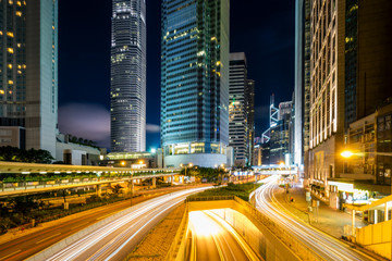Fototapete - Traffic at central district in Hong Kong at dusk time. Car light trails and urban landscape in Hong Kong .
