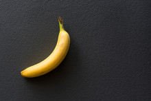 Lonely Yellow Banana On A Black Background.