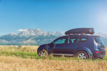 car for traveling with a roof rack on a mountain road