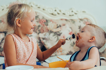 Wall Mural - Girl Feeding Her Little Brother with Ice-Cream