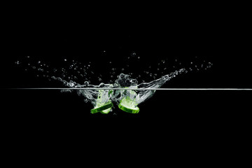 Wall Mural - cucumber in water with splash