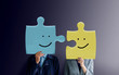 Happiness Couple or Business Partnership Concept. Portrait of two People with Happy Face Emotion on Jigsaw Puzzles