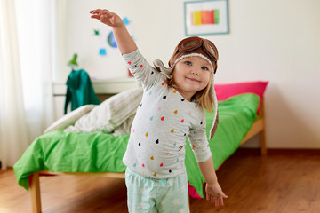 Poster - happy little girl in pilot hat playing at home