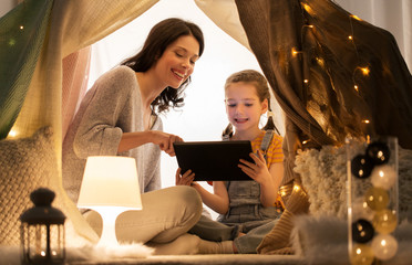 Poster - family with tablet pc in kids tent at home