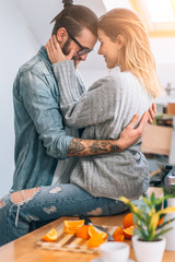 Wall Mural - Young couple having fun in kitchen 