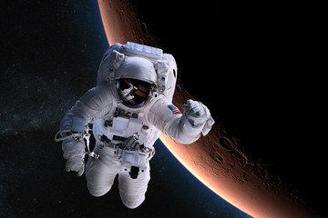 Wall Mural - astronaut in outer space on background of the mars. elements of this image furnished by nasa.