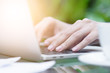 © Joeahead - Asian woman hands has touching and typing on laptop computer with blurred coffee, computer and view outside window.