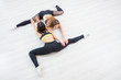 © Aleksei Lazukov - two young women lie on the floor in half cross-twine top view