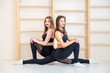 © Aleksei Lazukov - two young women symmetrically on  half twine in gym