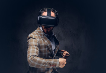 Studio portrait of a man wearing virtual reality glasses on a da