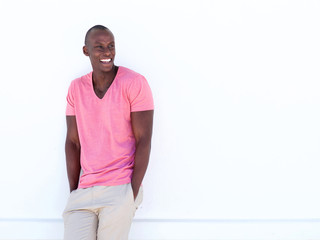 Wall Mural - cool african american man smiling by white wall