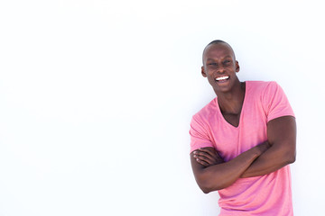 Wall Mural - handsome black man smiling with arms crossed on isolated white background