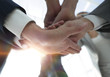 © ASDF - business people folding their hands together.