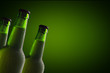 © karmaknight - Three Wet Bottles Of Beer Isolated On Green Background