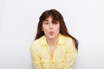 Canvas Print - Emotional portrait of a young beautiful girl on a white background.