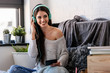 © lordn - Beautiful young woman at home enjoys listening music