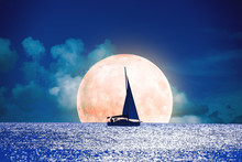 Silhouette Of A Boat With Full Moon On The Ocean. 