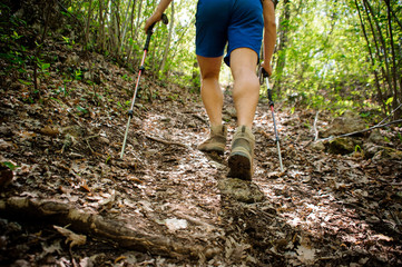active runner climbs up the mountain using special equipment