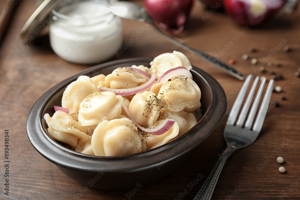 Bowl with tasty meat dumplings on table