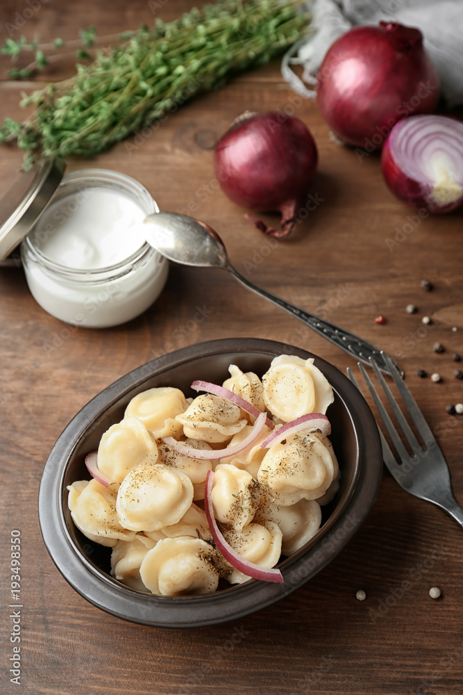 Bowl with tasty meat dumplings on table