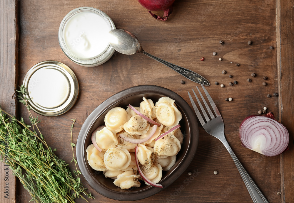 Bowl with tasty meat dumplings on table