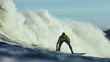 Man surfing in ocean against waves
