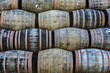 Stacked pile of old wooden barrels and casks at whisky distillery in Scotland