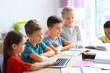 © Africa Studio - Cute children doing homework in classroom at school