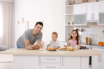 Poster - Father with children having breakfast in kitchen