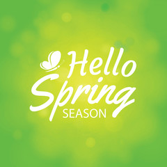 Wall Mural - Hello spring on green bokeh background. Greeting card design with text lettering.