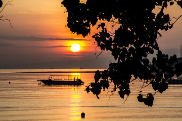 Wall Mural - Beautiful sunset with boat on beach in tropical Bali, Indonesia