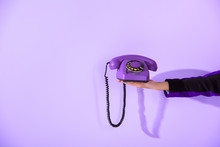Cropped View Of Girl Holding Vintage Rotary Phone At Ultra Violet Wall