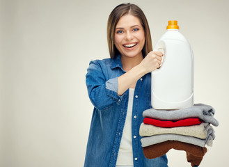 Wall Mural - woman holding stack of folded wool clothes with white detergent