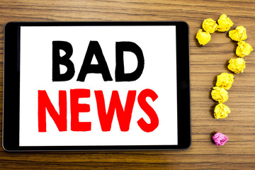 Writing text showing Bad News. Business concept for Failure Media Newspaper written on tablet computer on the wooden background with question mark made of folded paper.