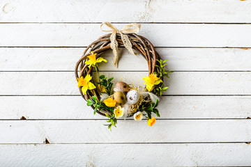 Wall Mural - Easter background with spring wreath hanging on door