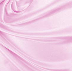Smooth elegant pink silk or satin texture as wedding background. Luxurious background design