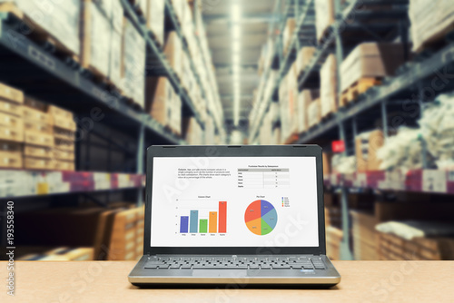 Fotografía Laptop with analysis sale screen on table with blur warehouse cargo in factory