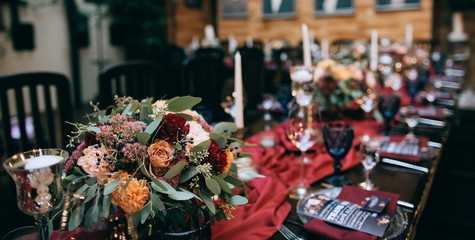 beautiful weding table decoration with red fresh flowers and candles