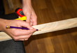 © yurich84 - Two hands holding plank and making a mark with pencil