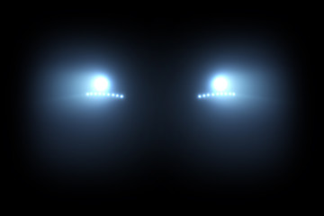 car head lights shining from darkness