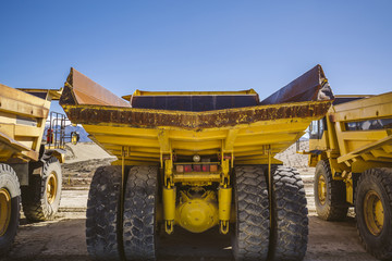 Dumper trucks parked on a construction site.