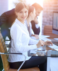 Poster - young employee sitting at a Desk