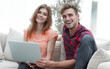 © ASDF - smiling couple resting at home,sitting on the couch.